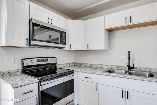 9570 E Sellarole Rd, Tucson, AZ 85730 - kitchen featuring stainless steel appliances, a sink, and white cabinetry