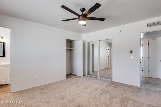 9570 E Sellarole Rd, Tucson, AZ 85730 - unfurnished bedroom with carpet floors, connected bathroom, two closets, ceiling fan, and baseboards