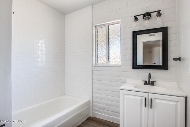 9570 E Sellarole Rd, Tucson, AZ 85730 - bathroom with wood finished floors, vanity, and baseboards