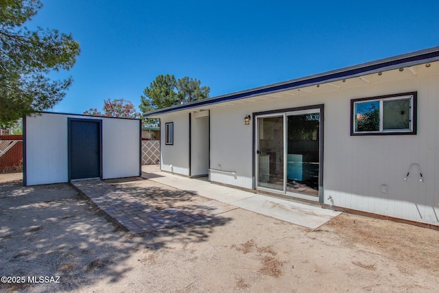9570 E Sellarole Rd, Tucson, AZ 85730 - back of property with a patio, an outdoor structure, a storage unit, and fence