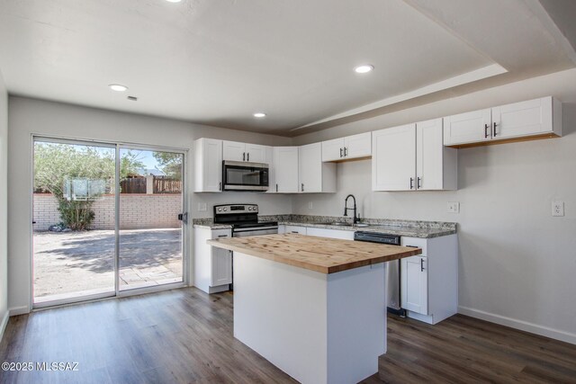 9570 E Sellarole Rd, Tucson, AZ 85730 - kitchen featuring stainless steel appliances, wood counters, a sink, baseboards, and dark wood-style flooring