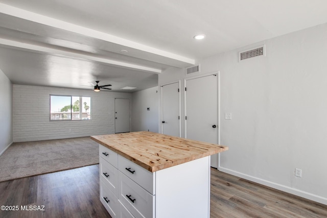 9570 E Sellarole Rd, Tucson, AZ 85730 - kitchen with butcher block countertops, white cabinets, ceiling fan, wood finished floors, and open floor plan