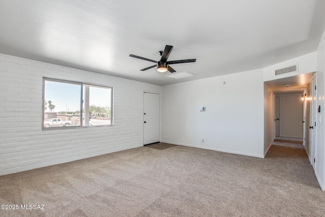 9570 E Sellarole Rd, Tucson, AZ 85730 - carpeted empty room featuring a ceiling fan and brick wall
