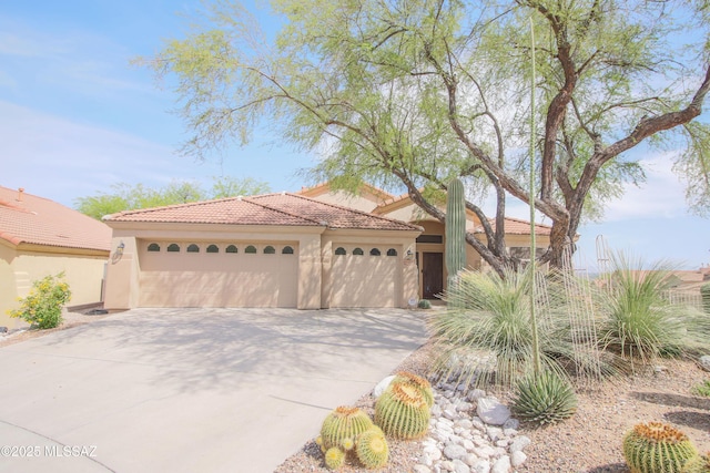 4416 N Saddle View Dr, Tucson, AZ 85750 - mediterranean / spanish house with concrete driveway, an attached garage, stucco siding, and a tiled roof