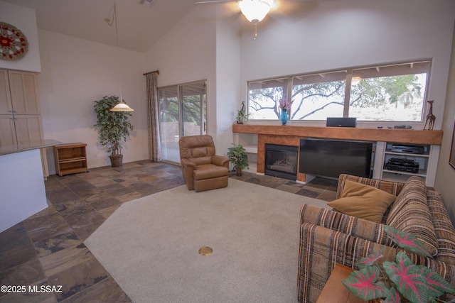 4416 N Saddle View Dr, Tucson, AZ 85750 - living area featuring high vaulted ceiling, ceiling fan, and a tiled fireplace