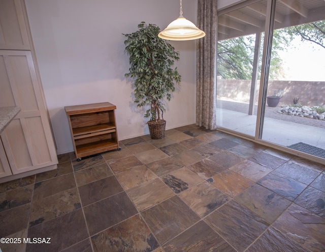 4416 N Saddle View Dr, Tucson, AZ 85750 - unfurnished dining area with stone tile floors and plenty of natural light