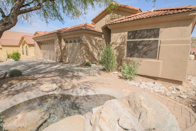 4416 N Saddle View Dr, Tucson, AZ 85750 - mediterranean / spanish-style house with an attached garage, stucco siding, driveway, and a tiled roof