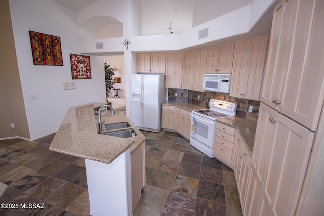 4416 N Saddle View Dr, Tucson, AZ 85750 - kitchen with white appliances, a sink, dark stone finish flooring, backsplash, and a high ceiling