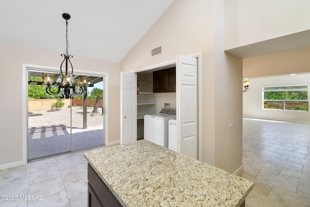 2742 S Via Del Bac, Green Valley, AZ 85622 - kitchen with a chandelier, separate washer and dryer, high vaulted ceiling, baseboards, and light stone counters