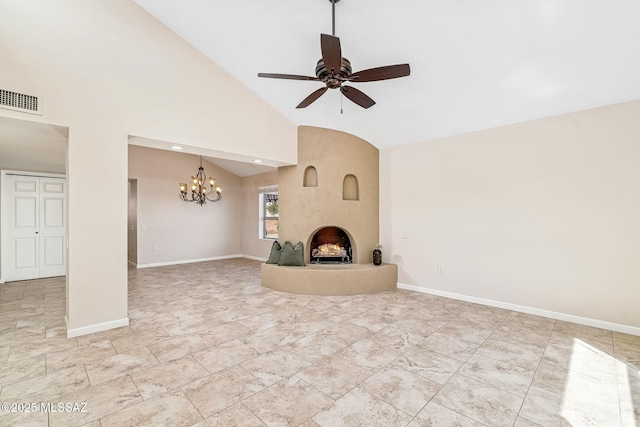 2742 S Via Del Bac, Green Valley, AZ 85622 - unfurnished living room featuring a chandelier, ceiling fan, a fireplace, high vaulted ceiling, and baseboards