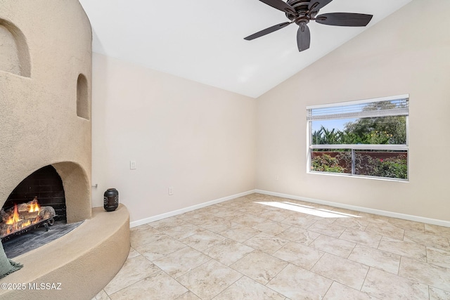 2742 S Via Del Bac, Green Valley, AZ 85622 - unfurnished living room featuring a warm lit fireplace, a ceiling fan, high vaulted ceiling, and baseboards