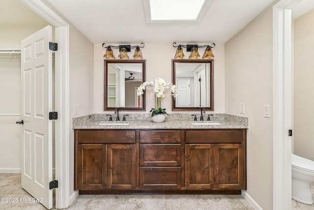 2742 S Via Del Bac, Green Valley, AZ 85622 - bathroom with toilet, double vanity, and baseboards