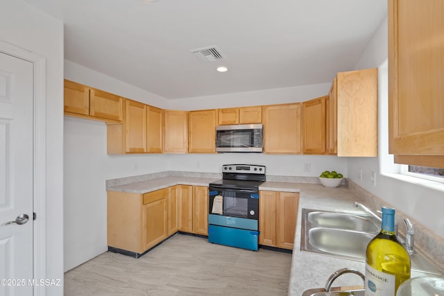 1846 Gardenias Ct, Rio Rico, AZ 85648 - kitchen with stainless steel microwave, range with electric cooktop, light countertops, a sink, and light marble finish flooring
