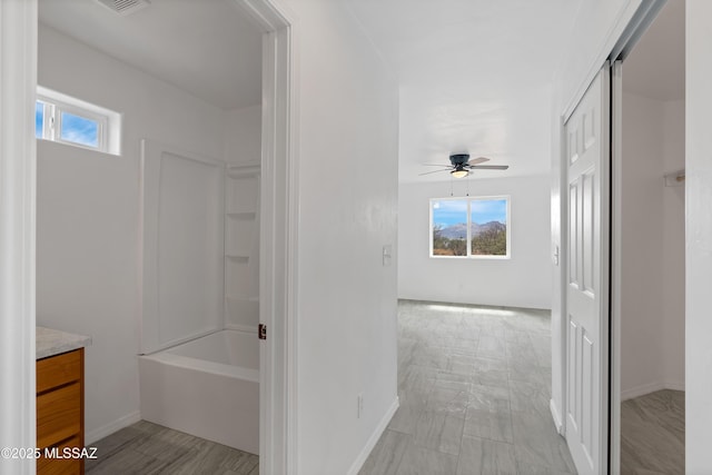 1846 Gardenias Ct, Rio Rico, AZ 85648 - full bath with healthy amount of natural light, ceiling fan, vanity, and baseboards