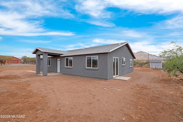 1846 Gardenias Ct, Rio Rico, AZ 85648 - rear view of house featuring stucco siding, a shingled roof, and a mountain view