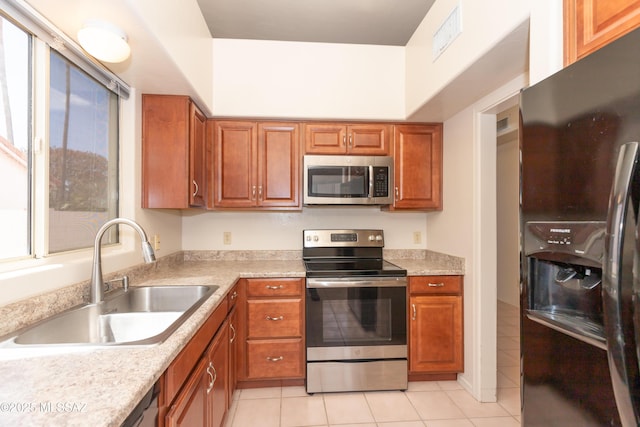 11629 N Copper Creek Dr, Oro Valley, AZ 85737 - kitchen featuring stainless steel appliances, a sink, brown cabinets, and light countertops