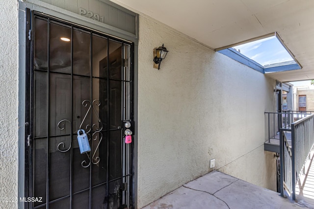 property entrance with stucco siding