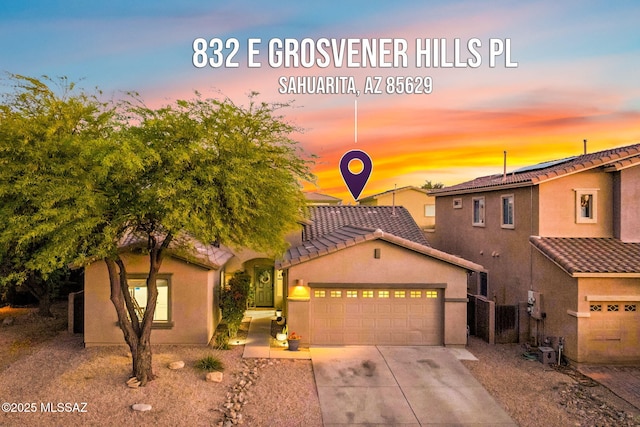 832 E Grosvener Hills Pl, Sahuarita, AZ 85629 - view of front facade with a garage, a tiled roof, driveway, and stucco siding