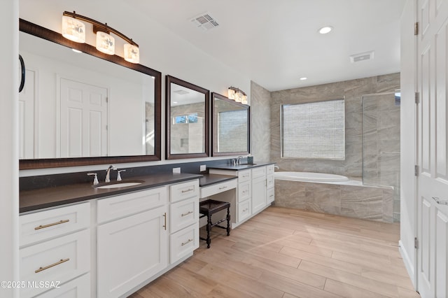 31566 S Misty Basin Rd, Oracle, AZ 85623 - full bath featuring double vanity, a bath, wood finished floors, a tile shower, and recessed lighting