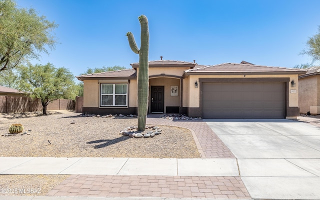 13570 E Hampden Green Way, Vail, AZ 85641 - view of front facade featuring stucco siding, driveway, an attached garage, and a tiled roof