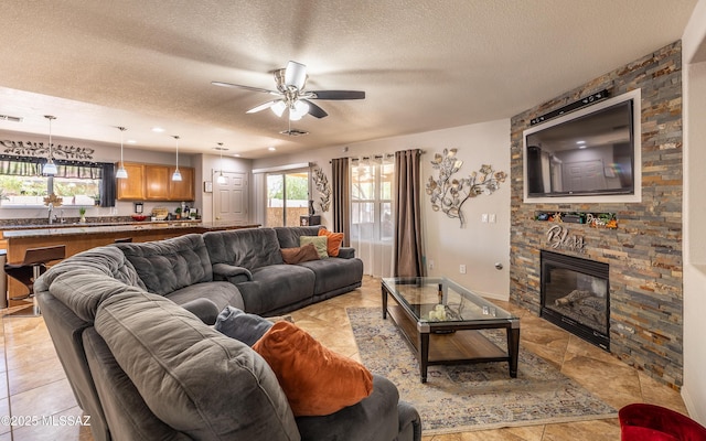 13570 E Hampden Green Way, Vail, AZ 85641 - living area with a textured ceiling, a ceiling fan, a fireplace, and recessed lighting