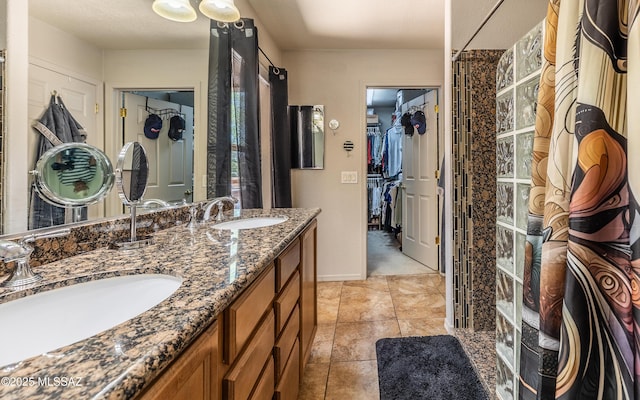 13570 E Hampden Green Way, Vail, AZ 85641 - bathroom featuring double vanity, a walk in closet, tile patterned floors, and baseboards