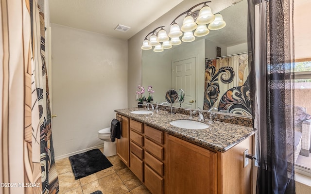 13570 E Hampden Green Way, Vail, AZ 85641 - full bath with double vanity, toilet, tile patterned flooring, and baseboards