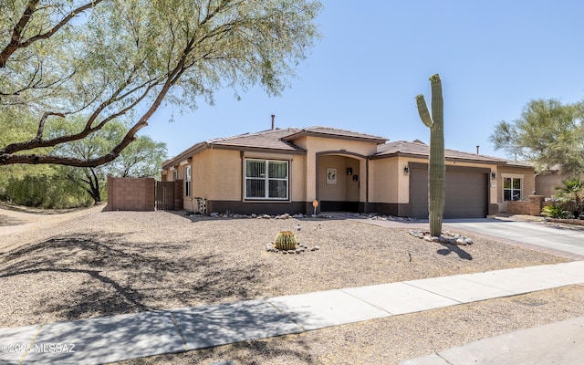 13570 E Hampden Green Way, Vail, AZ 85641 - view of front of home featuring stucco siding, an attached garage, a tile roof, and driveway