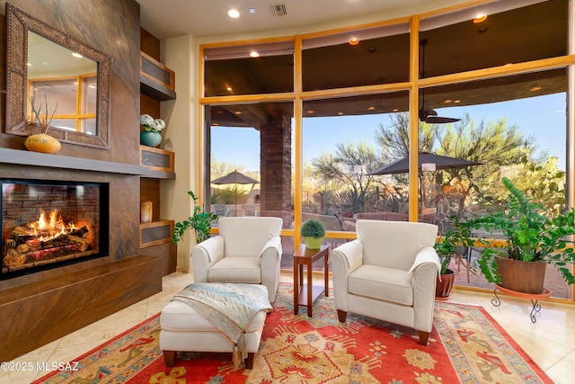 545 E Thunderstorm Pl, Oro Valley, AZ 85755 - sitting room featuring a premium fireplace, tile patterned floors, plenty of natural light, a wall of windows, and recessed lighting
