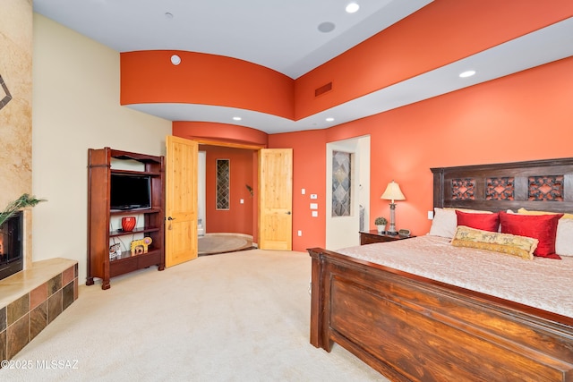 545 E Thunderstorm Pl, Oro Valley, AZ 85755 - bedroom with light colored carpet, recessed lighting, and a fireplace