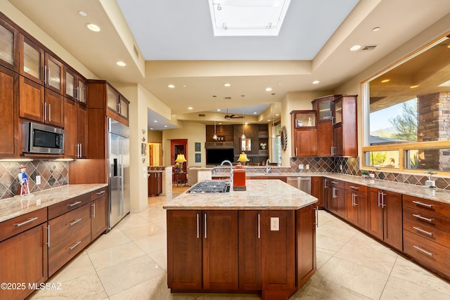 545 E Thunderstorm Pl, Oro Valley, AZ 85755 - kitchen with stainless steel appliances, open floor plan, backsplash, light stone countertops, and recessed lighting