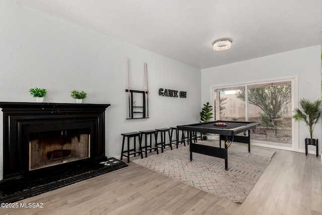 9870 N Meadow Flower Pl, Tucson, AZ 85742 - rec room featuring wood finished floors and a fireplace