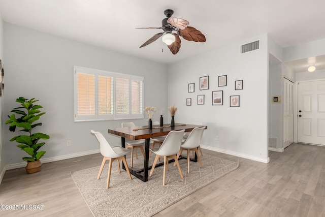 9870 N Meadow Flower Pl, Tucson, AZ 85742 - dining area with a ceiling fan, light wood-style floors, and baseboards
