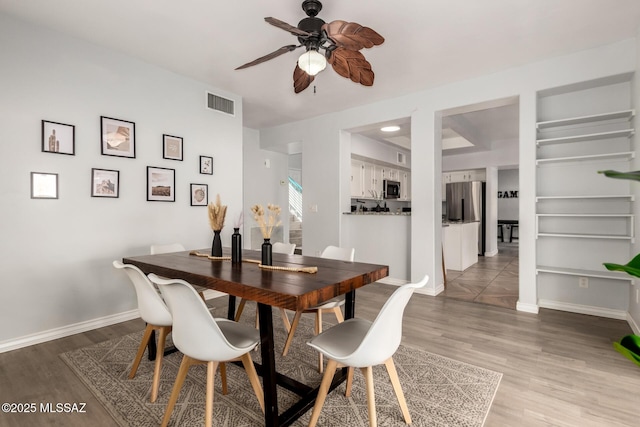 9870 N Meadow Flower Pl, Tucson, AZ 85742 - dining space featuring ceiling fan, wood finished floors, and baseboards