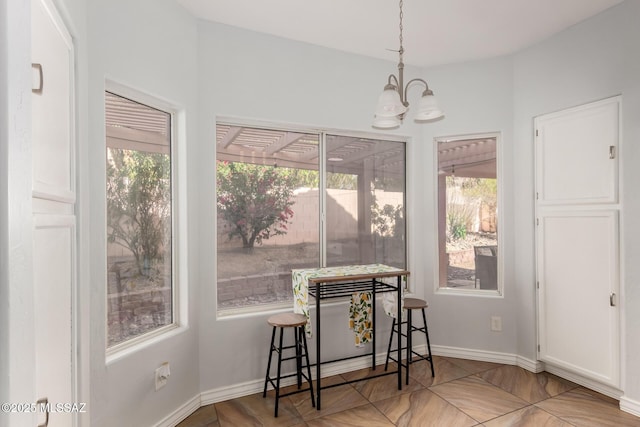 9870 N Meadow Flower Pl, Tucson, AZ 85742 - dining area with a chandelier and baseboards