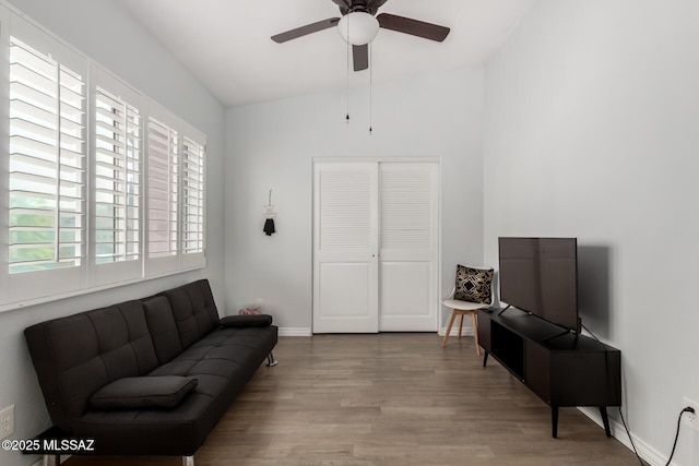 9870 N Meadow Flower Pl, Tucson, AZ 85742 - living area with a ceiling fan, lofted ceiling, wood finished floors, and baseboards