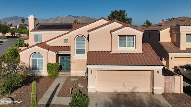 9870 N Meadow Flower Pl, Tucson, AZ 85742 - view of front facade with a tiled roof, a mountain view, driveway, and an attached garage