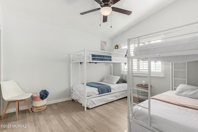 9870 N Meadow Flower Pl, Tucson, AZ 85742 - bedroom featuring wood finished floors, vaulted ceiling, baseboards, and a ceiling fan
