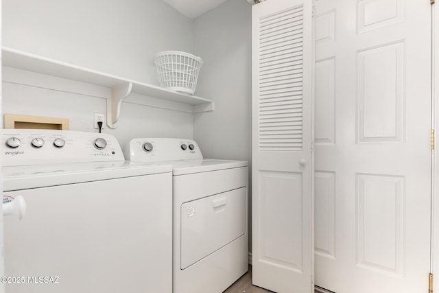 9870 N Meadow Flower Pl, Tucson, AZ 85742 - clothes washing area featuring washing machine and dryer and light wood-style flooring