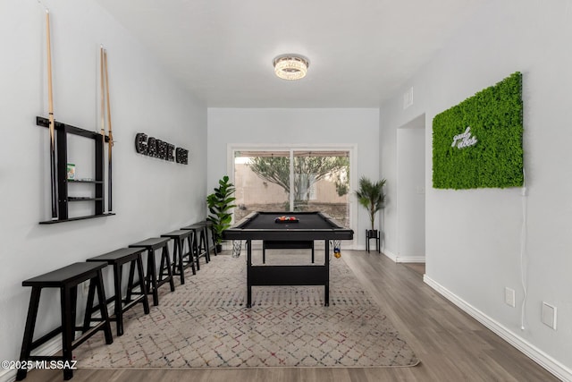 9870 N Meadow Flower Pl, Tucson, AZ 85742 - rec room with wood finished floors and baseboards