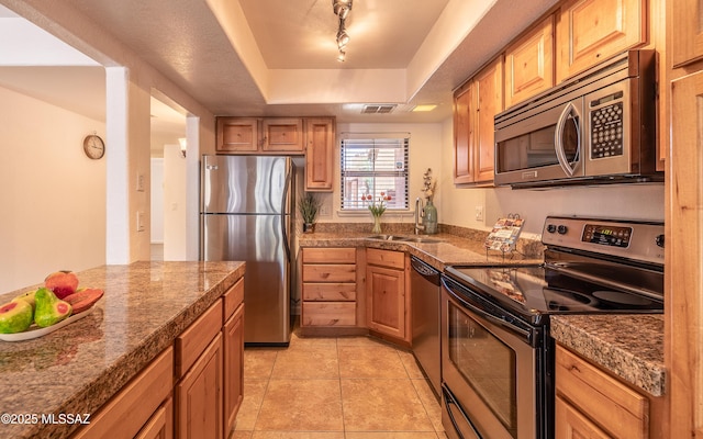 6651 N Campbell Ave Unit 133, Tucson, AZ 85718 - kitchen featuring appliances with stainless steel finishes, tile counters, a raised ceiling, a sink, and light tile patterned flooring