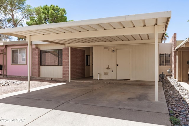 7244 S Camino Del Arco Iris, Tucson, AZ 85746 - view of front facade with brick siding, driveway, and an attached carport