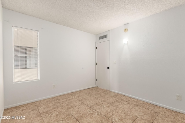 7244 S Camino Del Arco Iris, Tucson, AZ 85746 - unfurnished room featuring a textured ceiling and baseboards