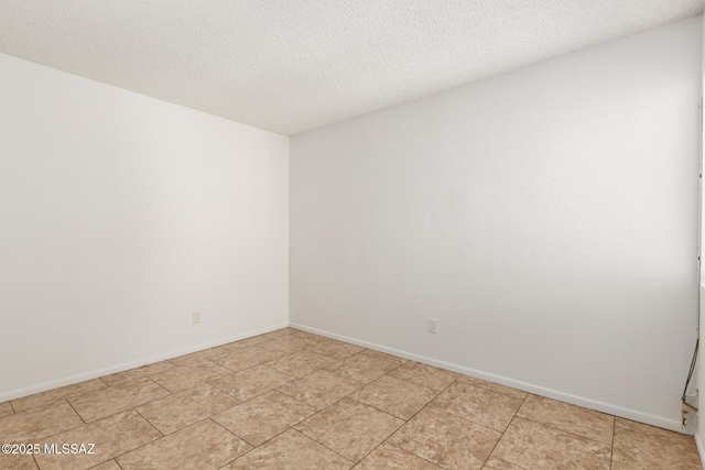 7244 S Camino Del Arco Iris, Tucson, AZ 85746 - spare room featuring a textured ceiling, baseboards, and light tile patterned flooring