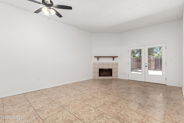 7244 S Camino Del Arco Iris, Tucson, AZ 85746 - unfurnished living room with french doors, a tile fireplace, ceiling fan, a textured ceiling, and baseboards