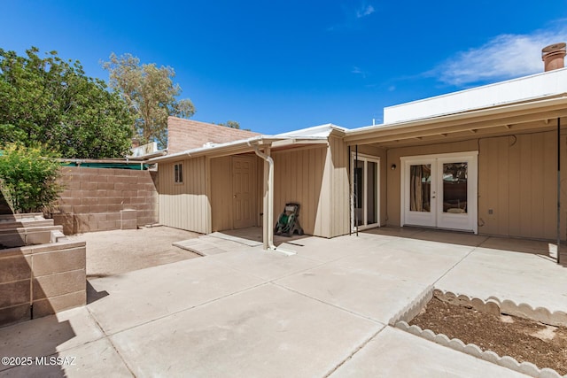 7244 S Camino Del Arco Iris, Tucson, AZ 85746 - view of patio / terrace with french doors, a storage unit, fence, and an outbuilding