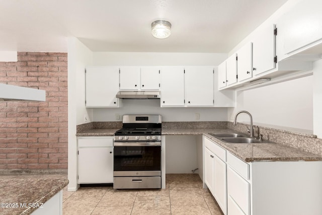 7244 S Camino Del Arco Iris, Tucson, AZ 85746 - kitchen with stainless steel gas range oven, a sink, under cabinet range hood, white cabinets, and light tile patterned floors