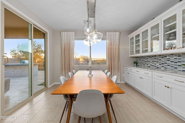 7106 W Foothills Acacia Pl, Marana, AZ 85658 - dining area with healthy amount of natural light, baseboards, light tile patterned floors, and a chandelier