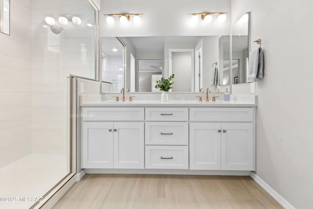 7106 W Foothills Acacia Pl, Marana, AZ 85658 - bathroom with tiled shower, double vanity, and baseboards