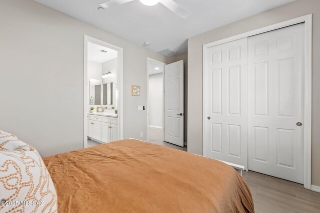 7106 W Foothills Acacia Pl, Marana, AZ 85658 - bedroom featuring a closet, ensuite bath, ceiling fan, and baseboards